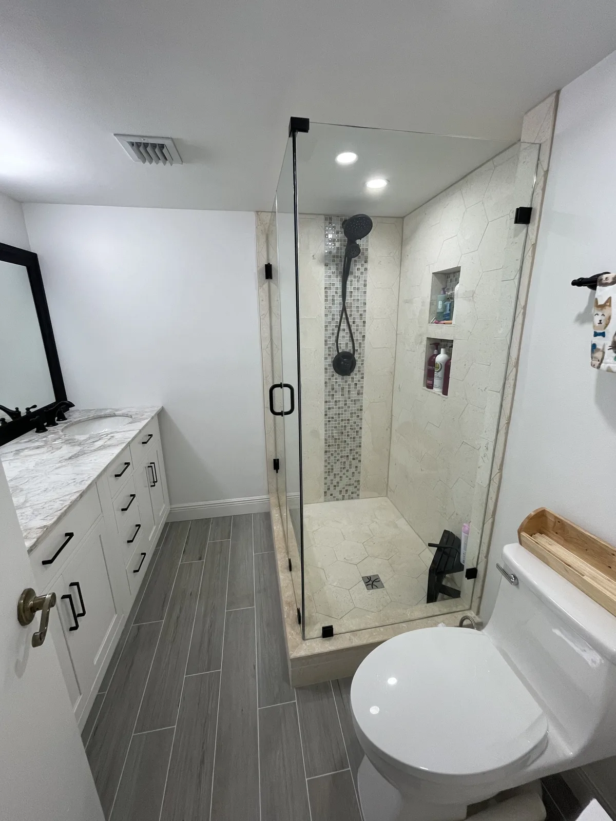 Bright remodeled guest bath with hexagon marble floor in Pembroke Pines, FL