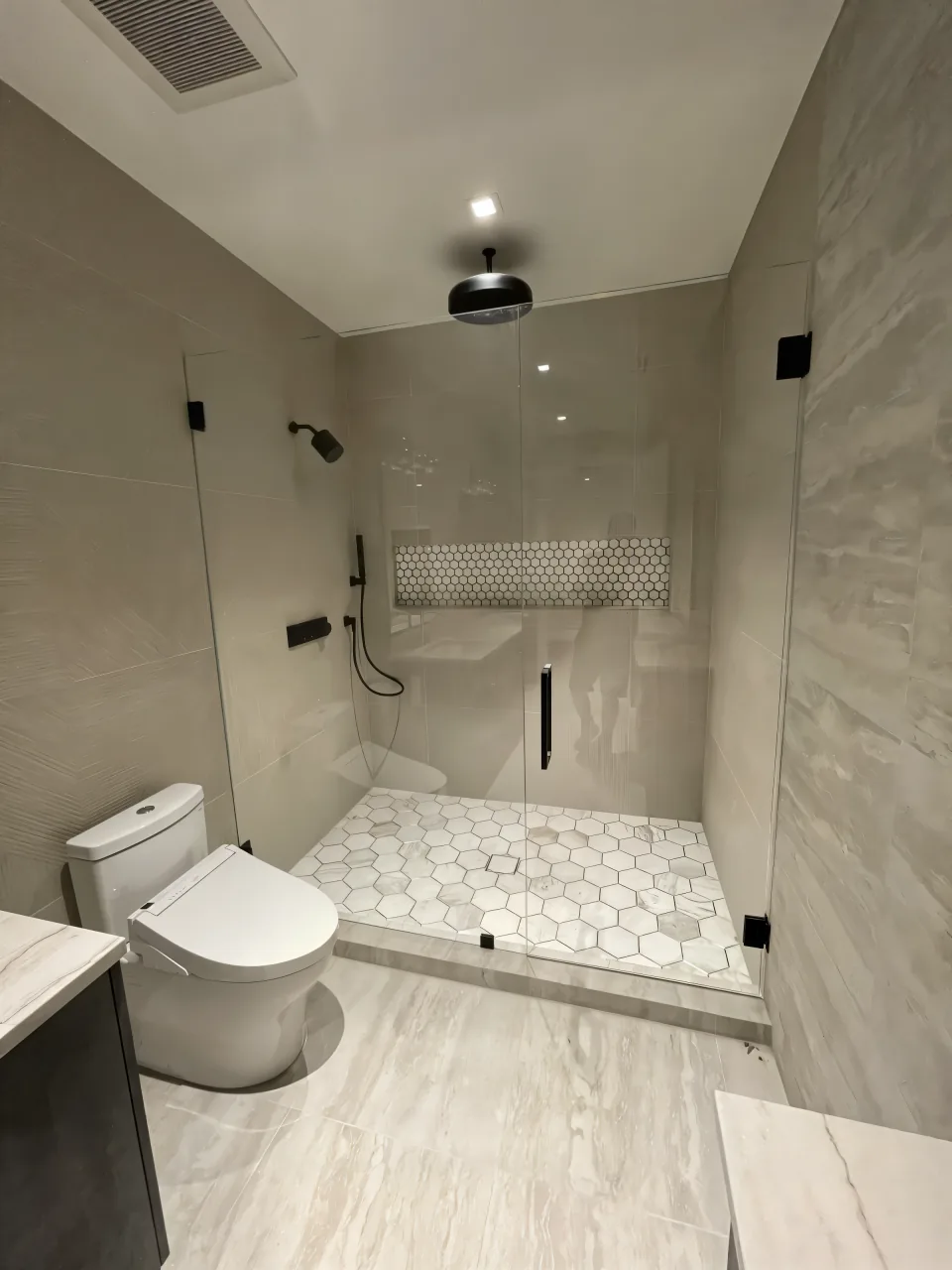 The same Plantation Acres hall bathroom after the remodel, bright with new tile and a new vanity