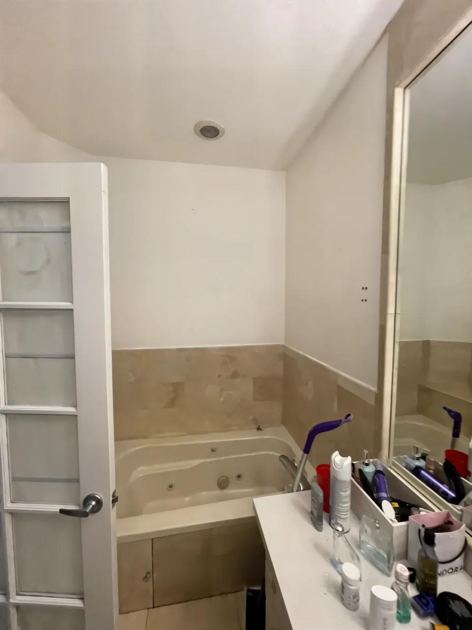 Dated hall bathroom in Plantation Acres with an old tub-and-tile combo before the remodel