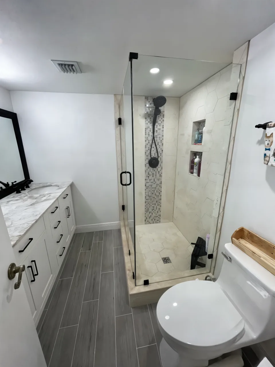 The same shower opened up with frameless glass, new tile and a tiled bench